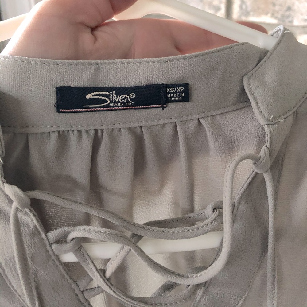 Women’s silver jeans blouse size XS never worn